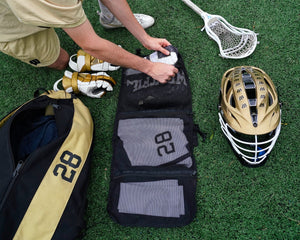athlete packing lacrosse uniform in bag